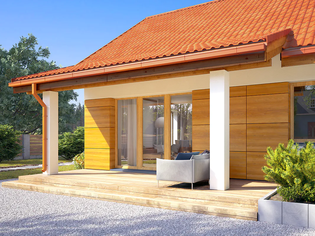 długi biały dom parterowy z pomarańczowym dachem i brązowymi wykończeniami z podwórkiem tył